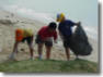 kids picking up litter on beach